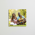 9-piece custom photo puzzle magnet set showing one family portrait split across nine 2x2 square magnets arranged in a 3x3 grid on a refrigerator
